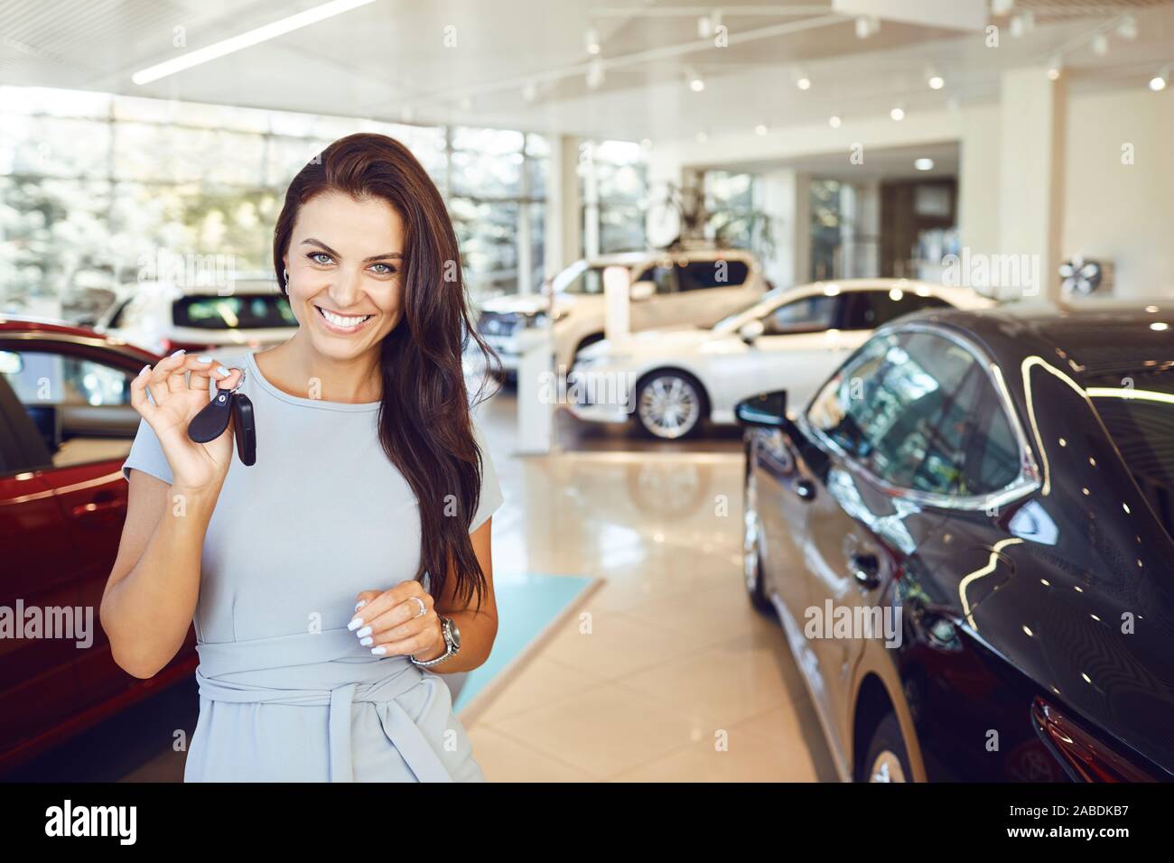 A female buyer is sitting in a new car. Stock Photo