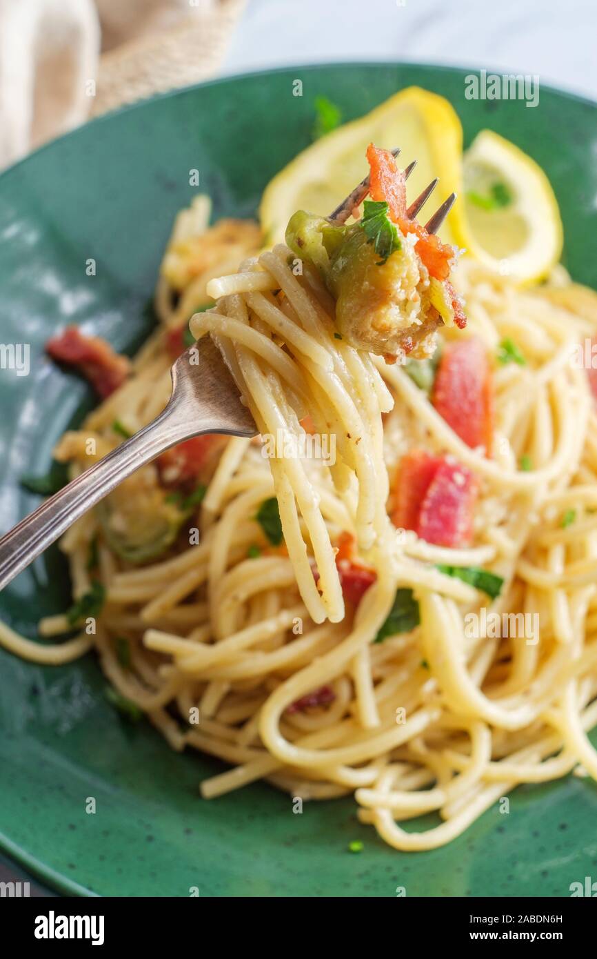 Creamy Italian cuisine spaghetti alla carbonara with bacon and brussel