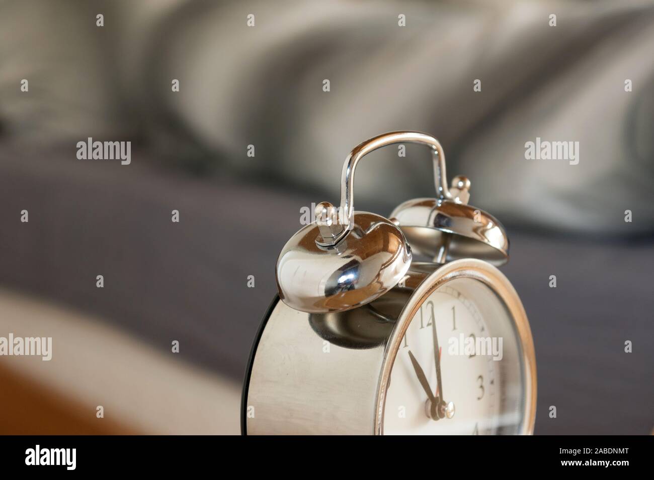 An alarm clock at the bed Stock Photo