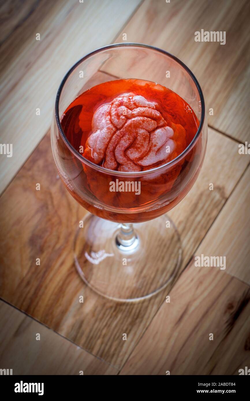 Human brain in red wine glass soaking for alcoholism addiction concept