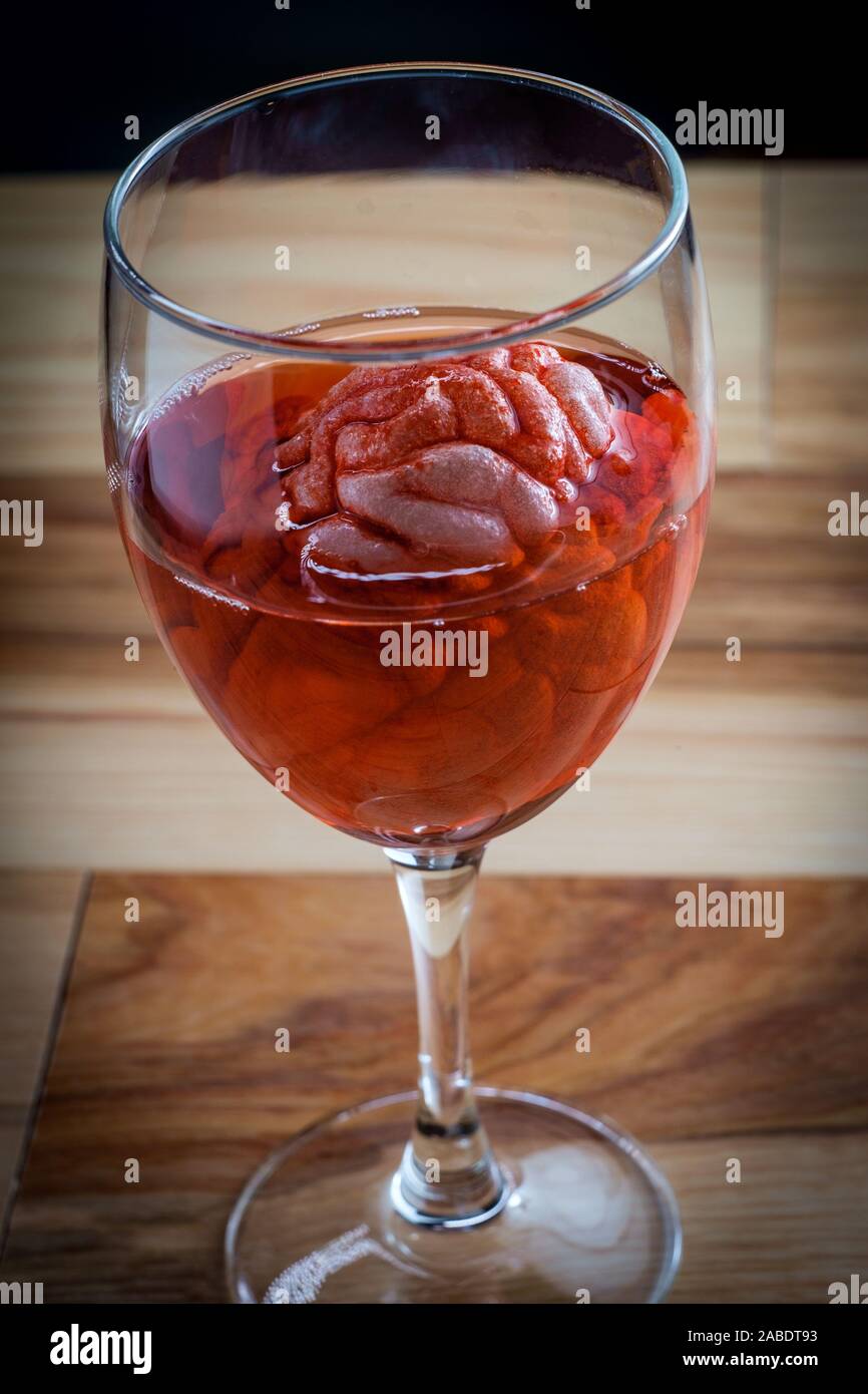 Human brain in red wine glass soaking for alcoholism addiction concept