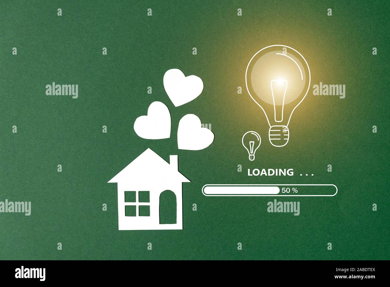 Home Loading Image Loading with paper house, light bulb image and heart shape on green ...