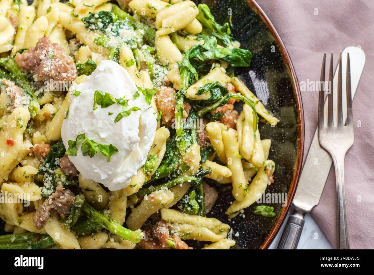 Italian spicy sausage ricotta cavatelli pasta and broccoli rabe Stock