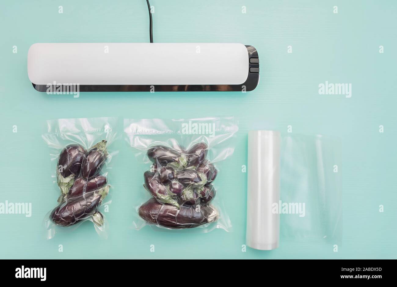 Plastic sealing machine. Vacuum packaging of fresh tomatoes. Vacuum