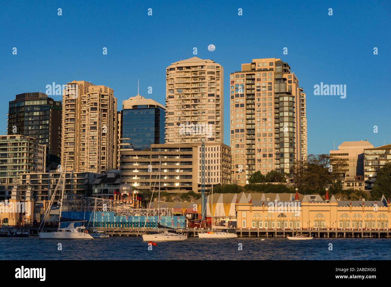 Milsons Point skyline wih full moon over buildings and Lavender bay with yachts . Sydney, Australia Stock Photo