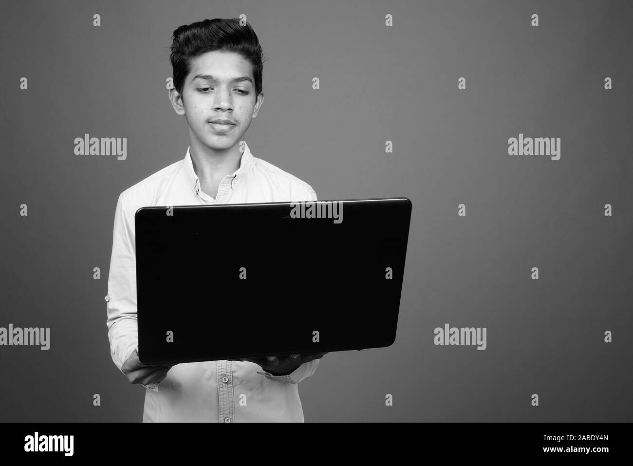 Young Indian boy looking smart in black and white Stock Photo