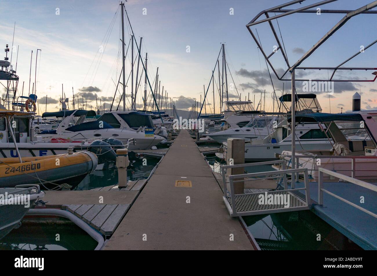 Airlie Beach, Australia - February 4, 2017: Abel Point Marina berth, mooring with yachts and boats at sunset, dusk Stock Photo