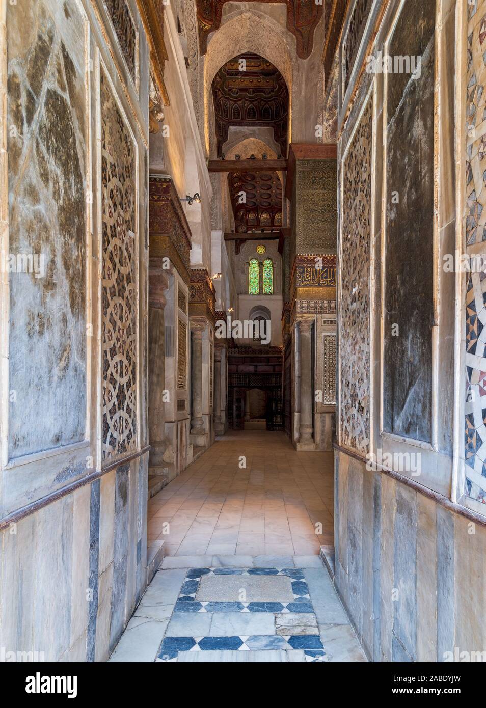 Passage with decorated marble walls at the Mausoleum of Sultan Qalawun, part of Sultan Qalawun Complex, located in Al Moez Street, Old Cairo, Egypt Stock Photo