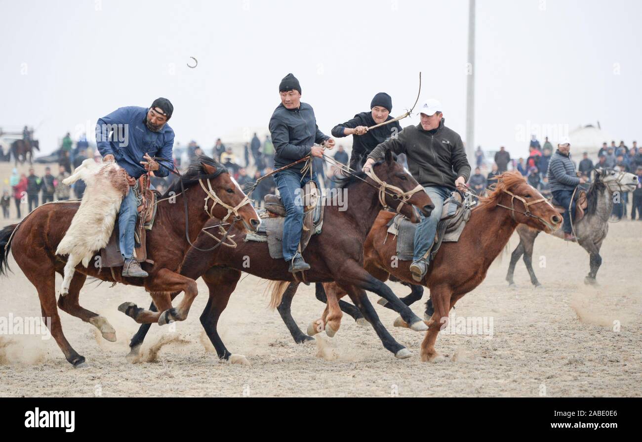 Horse riders race horses at the sports game in Altay city, north-west China's Xinjiang Uygur Autonomous Region, 27 October 2019. Stock Photo