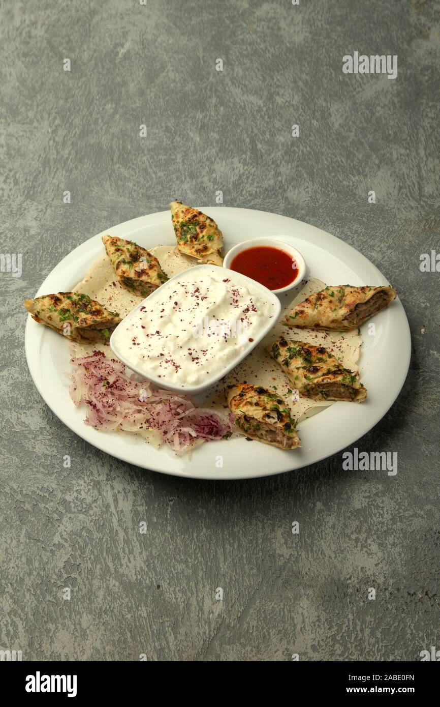 lule kebab wrapped in flatbread, served with yoghurt and tomato sauce Stock Photo Alamy
