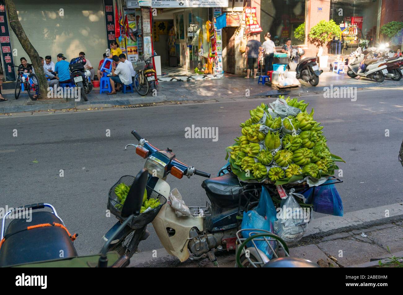 Hanoi, Vietnam - August 21, 2017: Pile of Buddha hand fruits on scooter. Street market scene Stock Photo