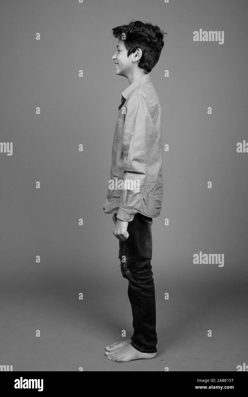 Young Indian boy wearing smart casual clothing against gray background Stock Photo