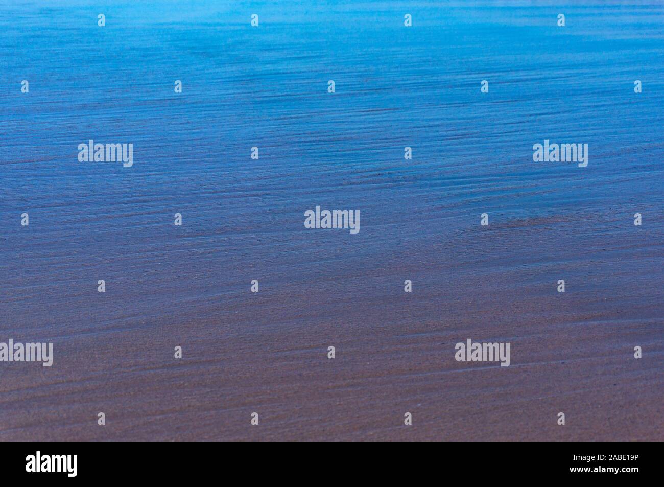 Wet sand with reflected sky abstract nature background Stock Photo