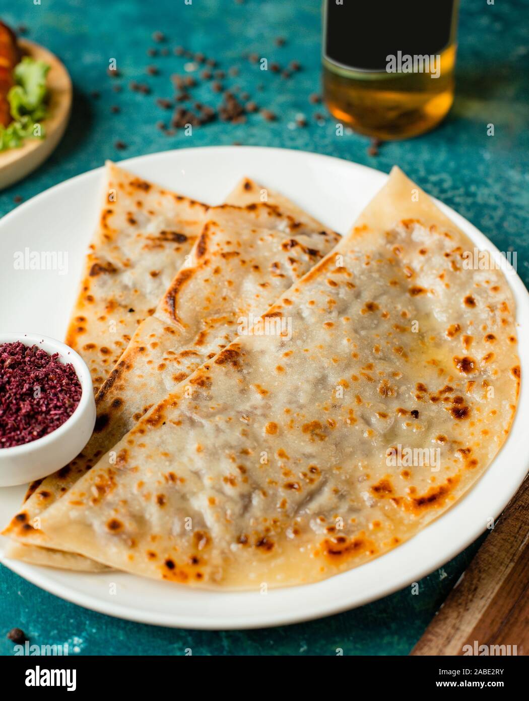 azerbaijani gutab stuffed flatbread with minced meat served with sumac