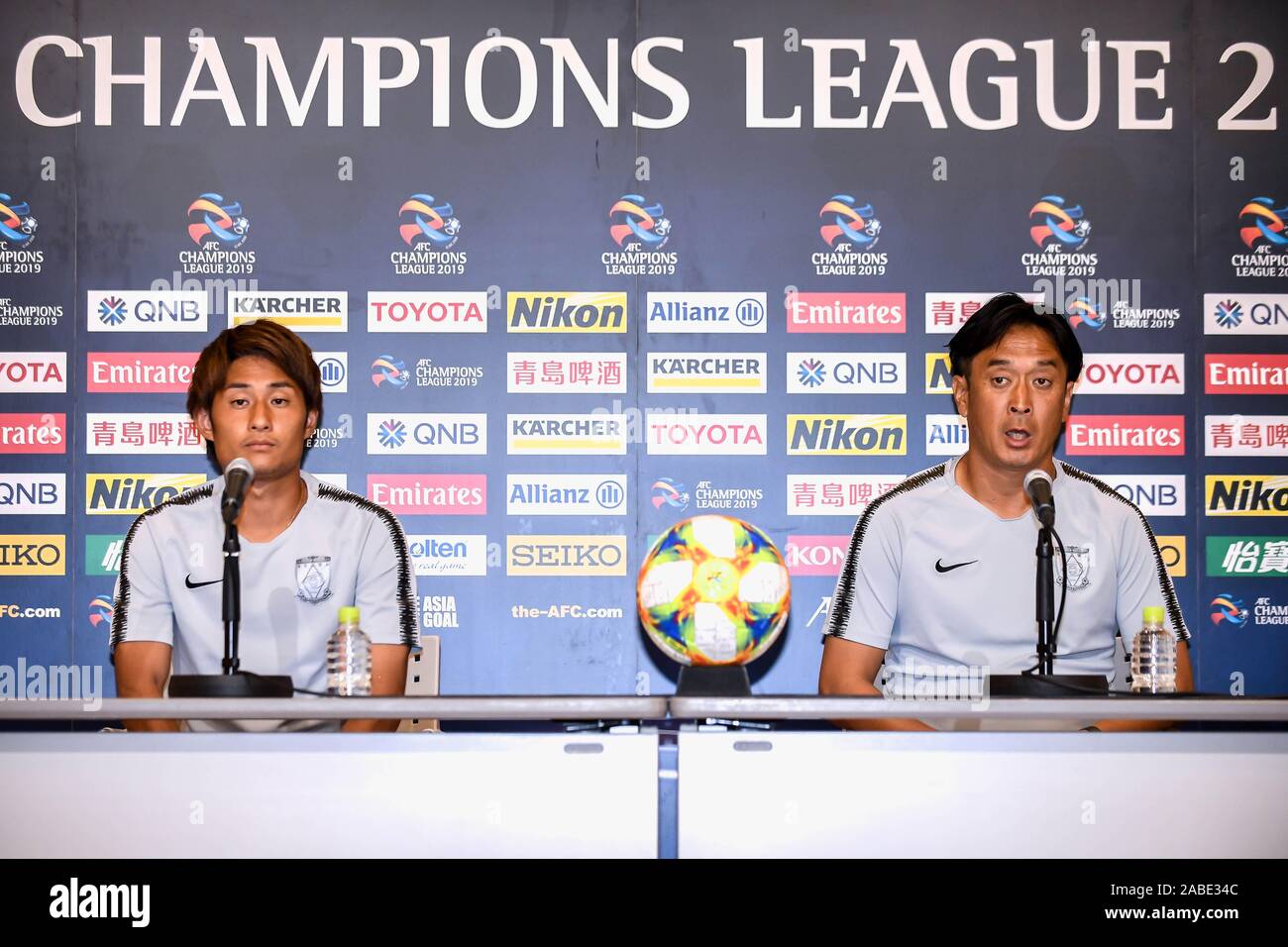 Takahiro Sekine, Japanese footballer who plays as a midfielder for Urawa Red Diamonds, left, and coach Tsuyoshi Otsuki speak at the press conference b Stock Photo