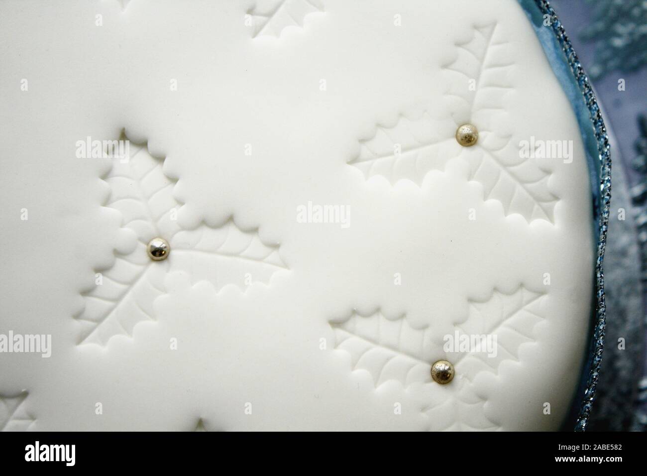 close up with fine details on a white icing Christmas cake, holy impressions, blue tones Stock Photo
