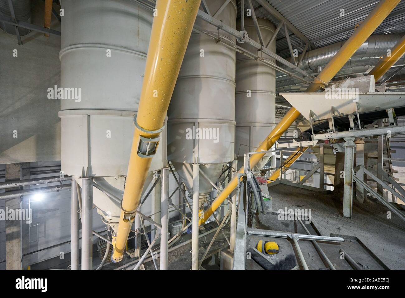 Large industrial mixer, for mixing ingredients into liquid cement.. Workers in the of