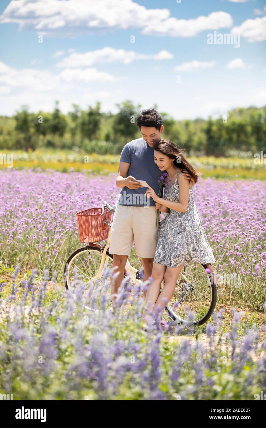 Happy young couple using smartphone Stock Photo