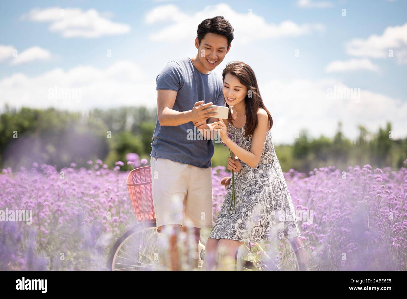Happy young couple using smartphone Stock Photo