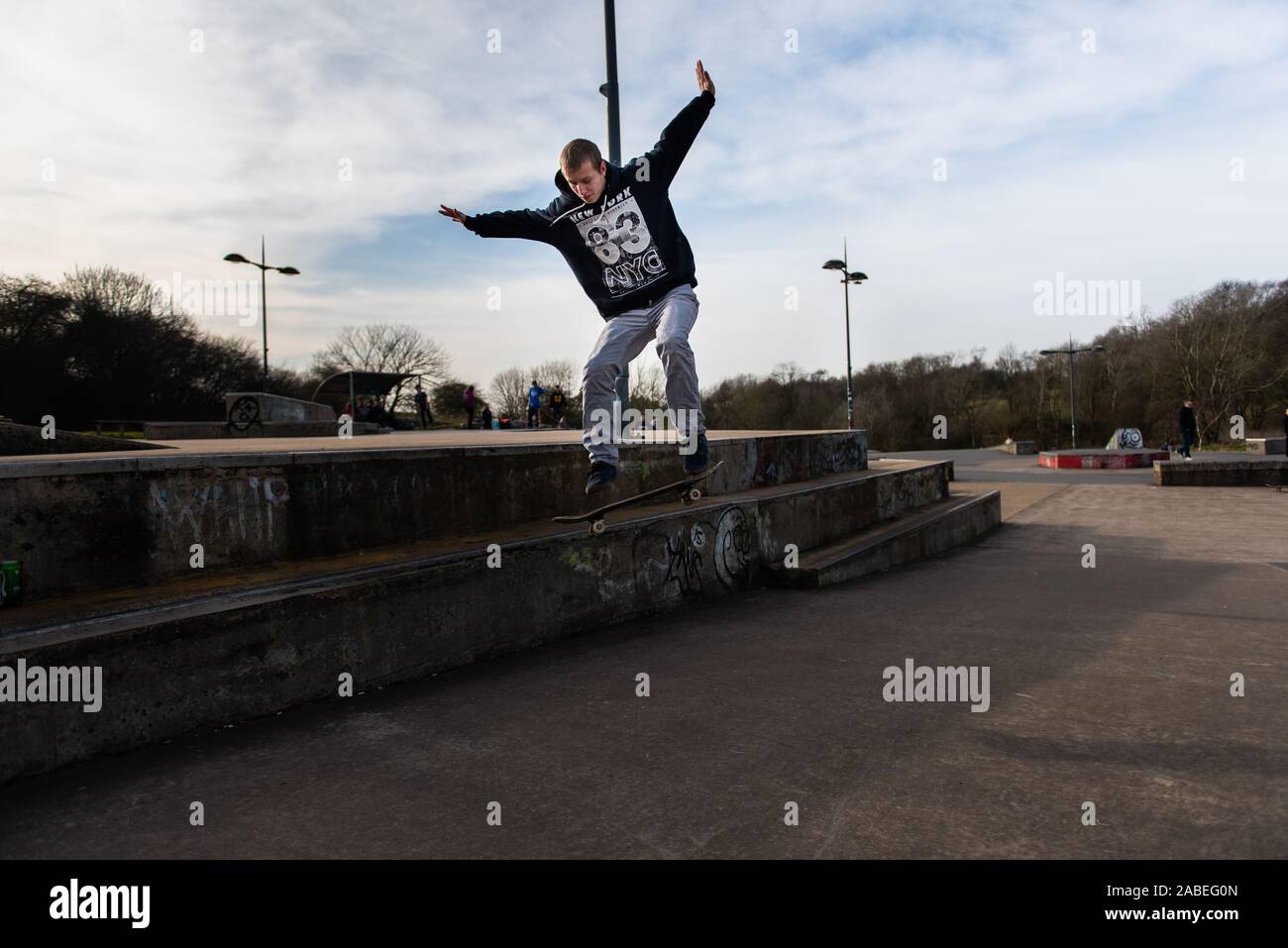 A group of professional skaters, skateboarders practicing ollieing off