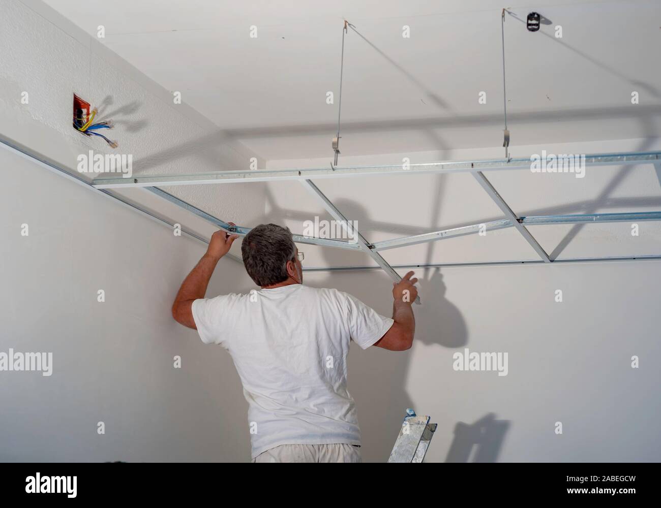 Construction Worker Assemble A Suspended Ceiling With