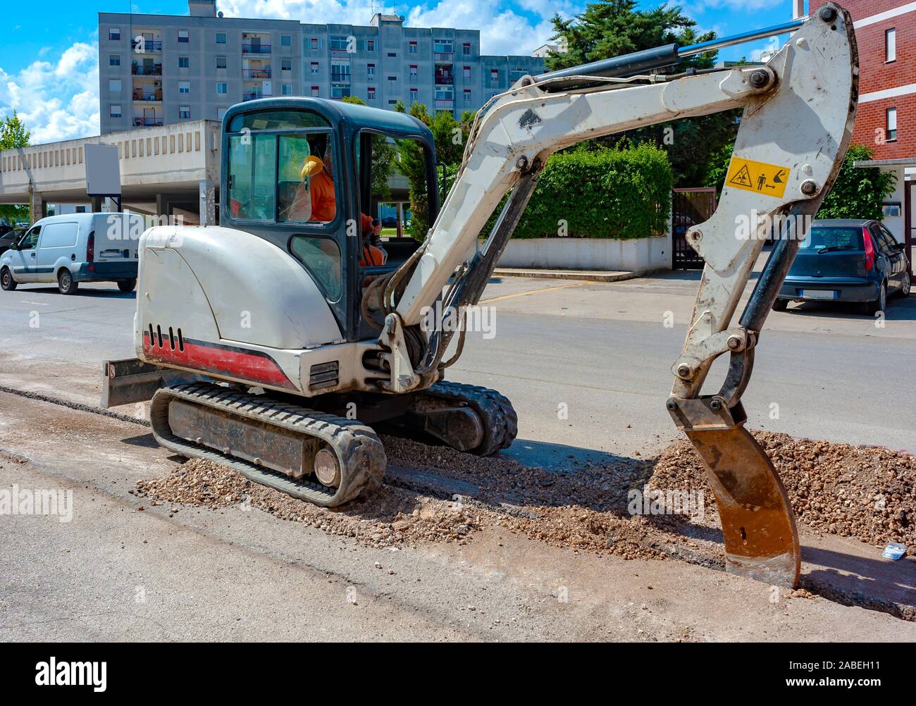 Mini excavator with narrow bucket for laying fiberoptic cable line Stock Photo Alamy