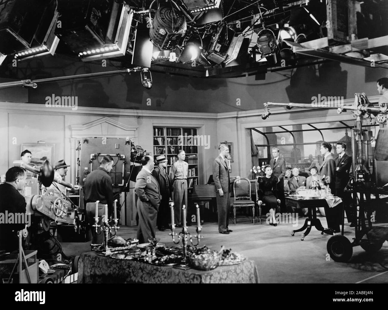 ROPE, Alfred Hitchcock (hands in pocket) rehearses his cast, from center James Stewart, Joan