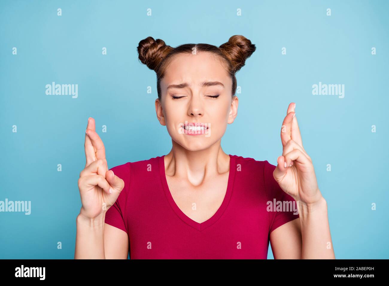 Close up photo of worried troubled stressed girl with fingers crossed