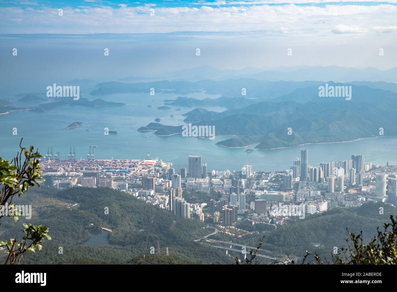 Panorama view of Shenzhen cityscape in direction of Yantian district and Hongkong island from top of Wutong Mountain on a sunny day, Guangdong, China Stock Photo