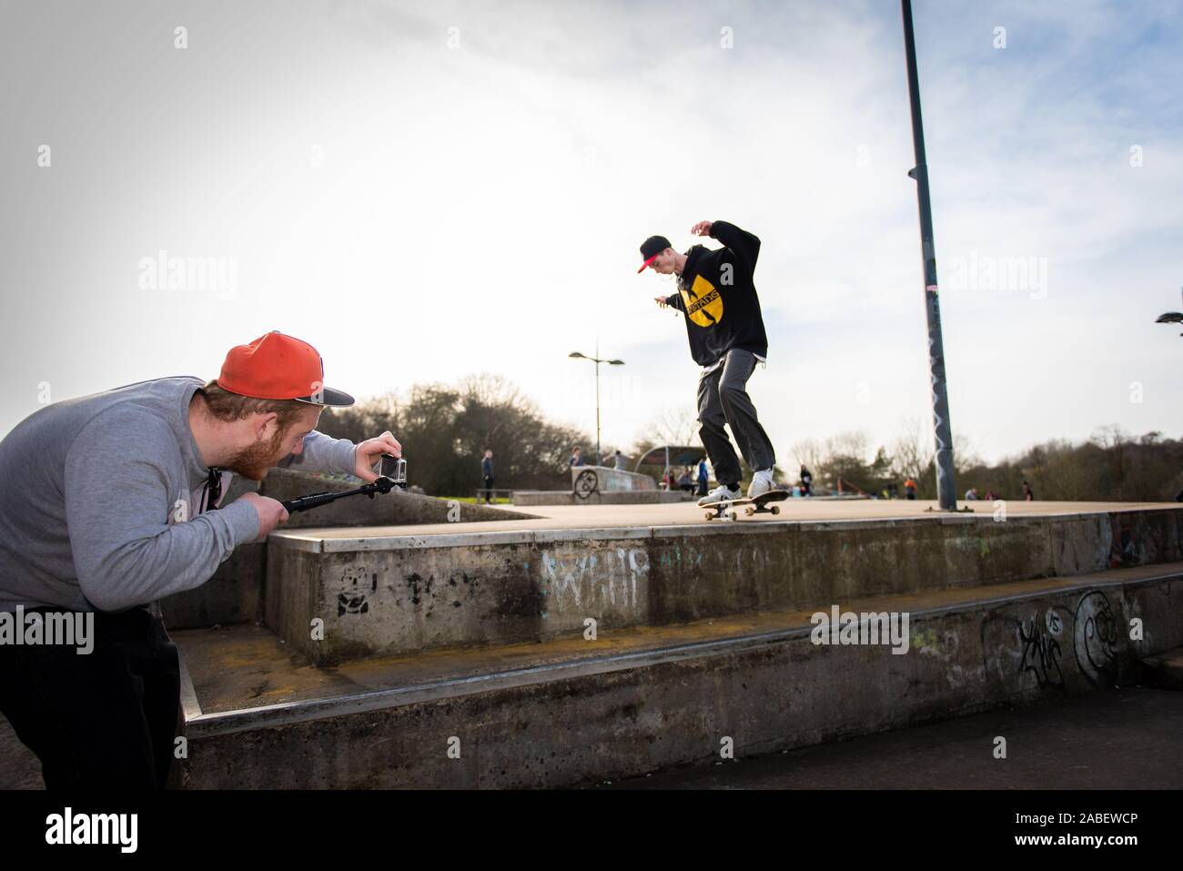 A group of professional skaters, skateboarders practicing ollieing off high steps and catching