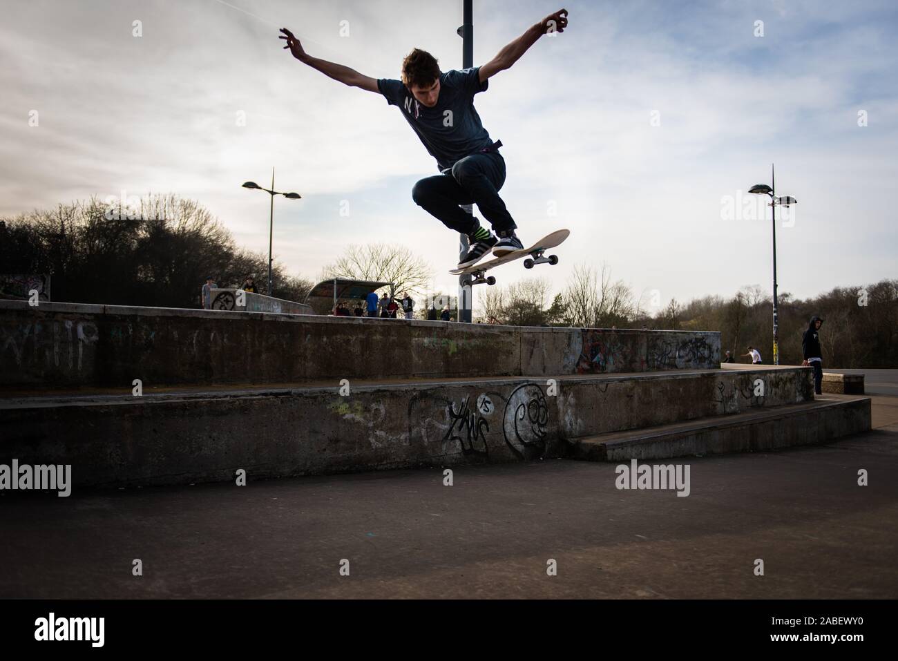 A group of professional skaters, skateboarders practicing ollieing off
