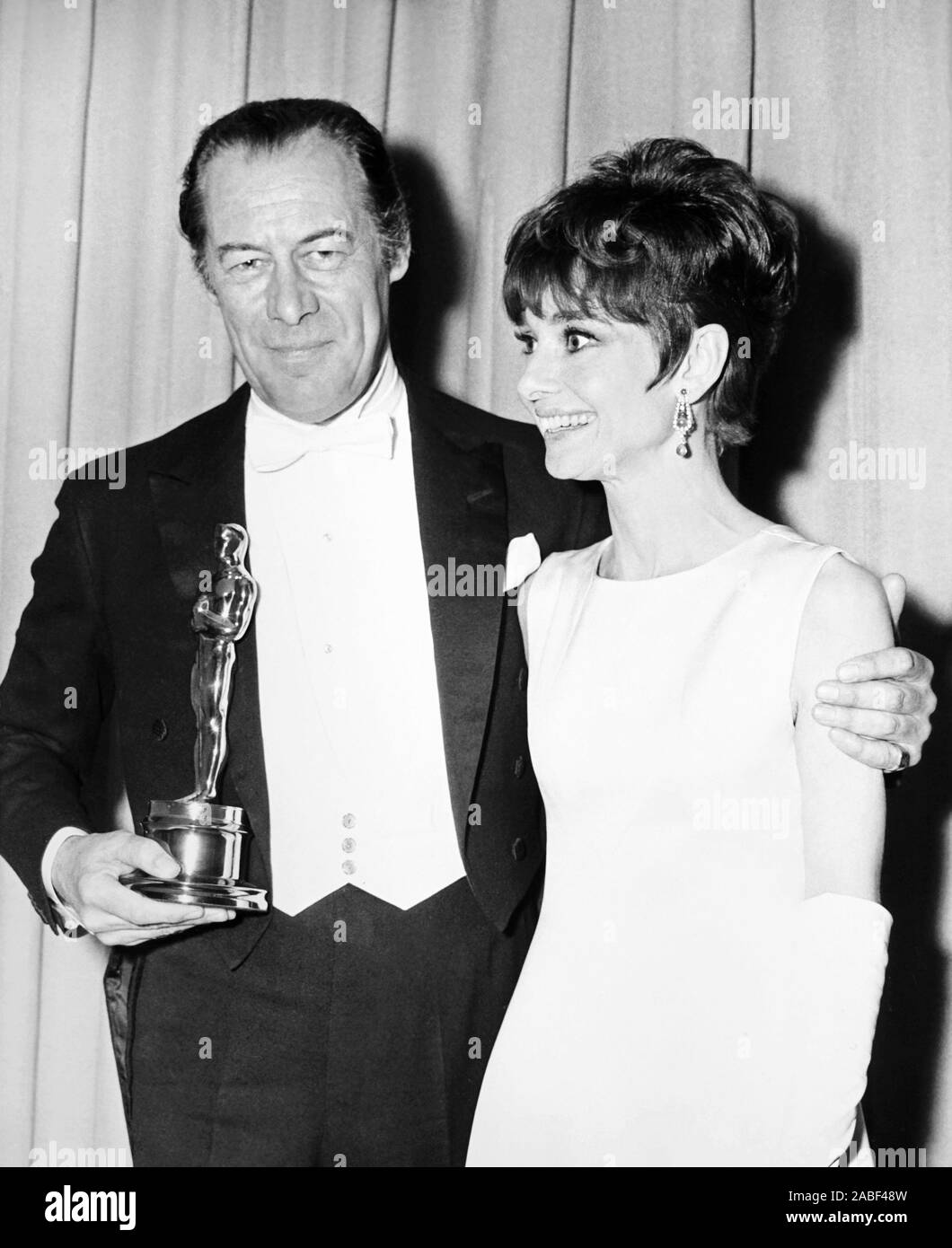 Audrey Hepburn at the Academy Award with Academy Award winner Rex Harrison holding his Oscar