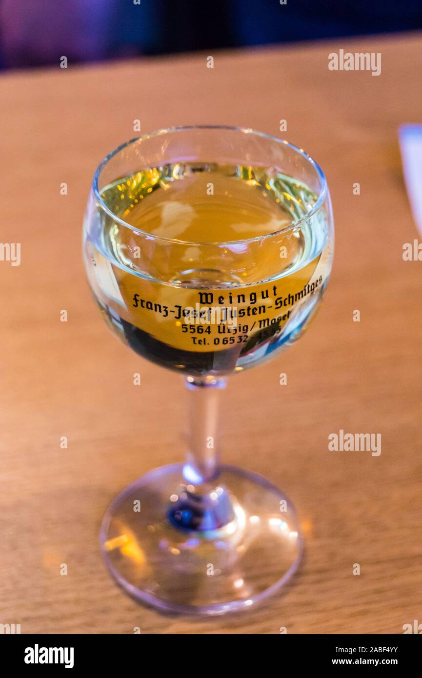 A  glass  of Riesling wine by Weingut Justen-Schmitges, Ürzig, Mosel, Rheinland-Pfalz, Germany on a stand at the wine festival Stock Photo