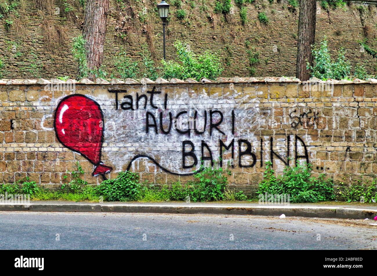 a wall painting saying happy birthday baby in italian language Stock Photo Alamy