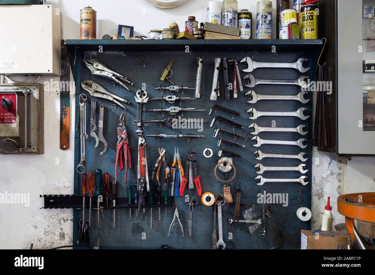 Detail of a wall unit with several utensils and tools in a garage Stock Photo