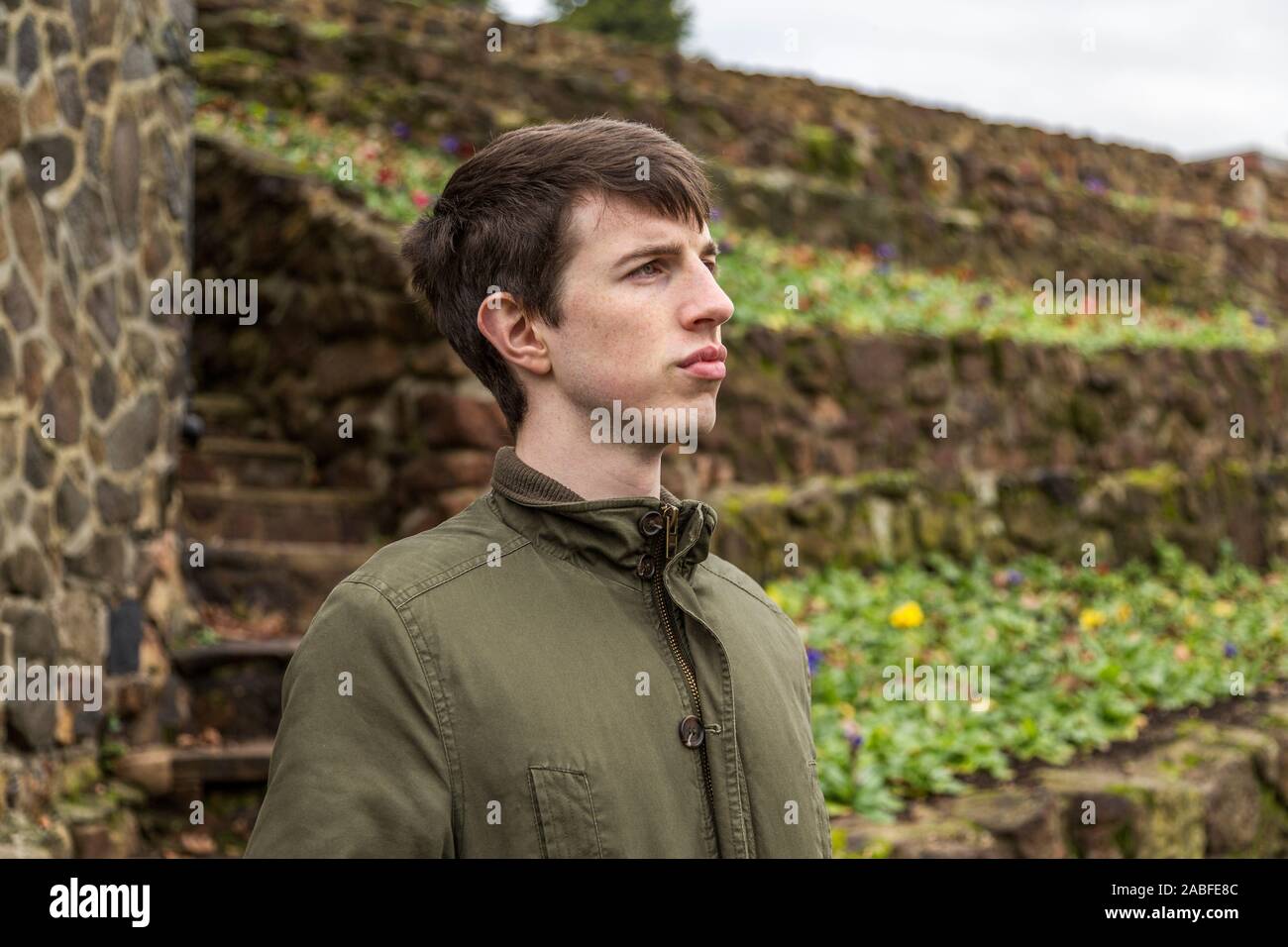 A handsome young man in his late teens or early twenties looking into the distance with a strong optimistic expression. Stock Photo