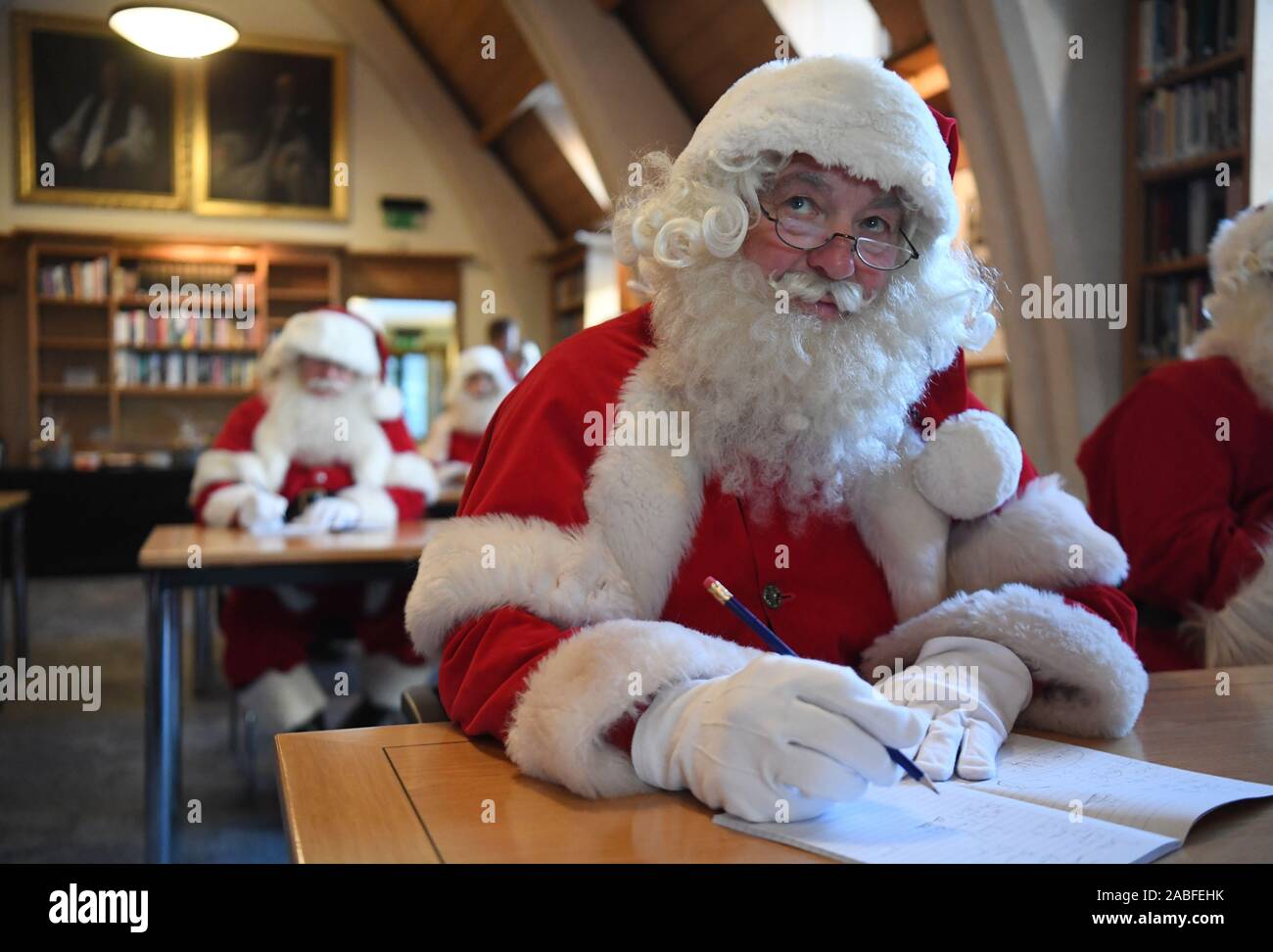 Father Christmas performers in a classroom during the 23rd annual Santa School at Southwark Cathedral in London. Stock Photo