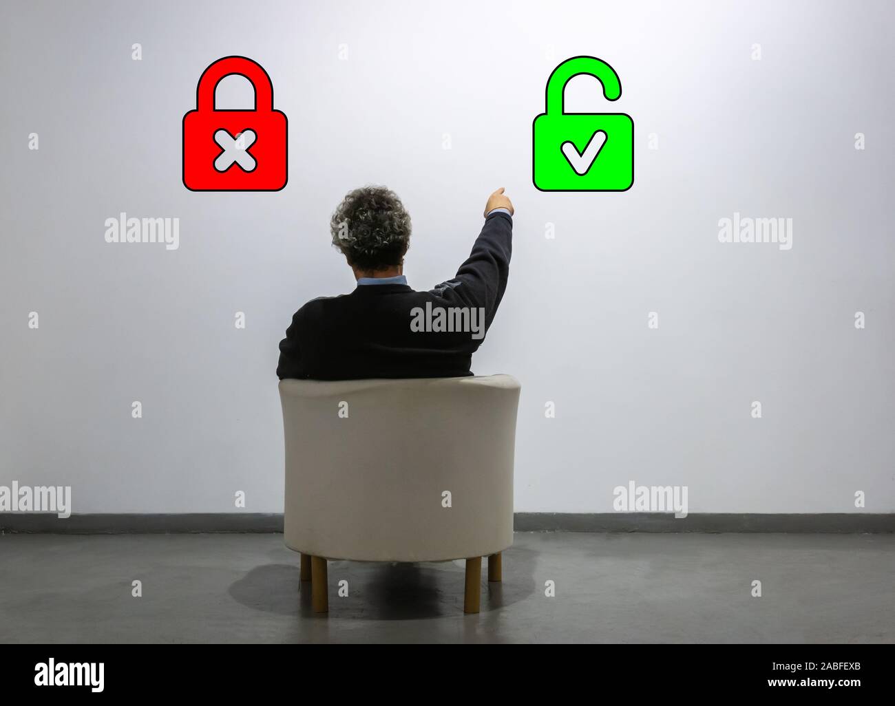 a man looks at two padlocks and points to the open one. Concept of choice, new solutions. Electronic security login Stock Photo