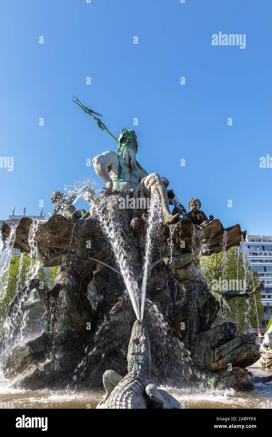 Close view of the Neptune Fountain with the sculpture of Roman god Neptune sitting on top, located on the Alexander Square in center of Berlin, German Stock Photo