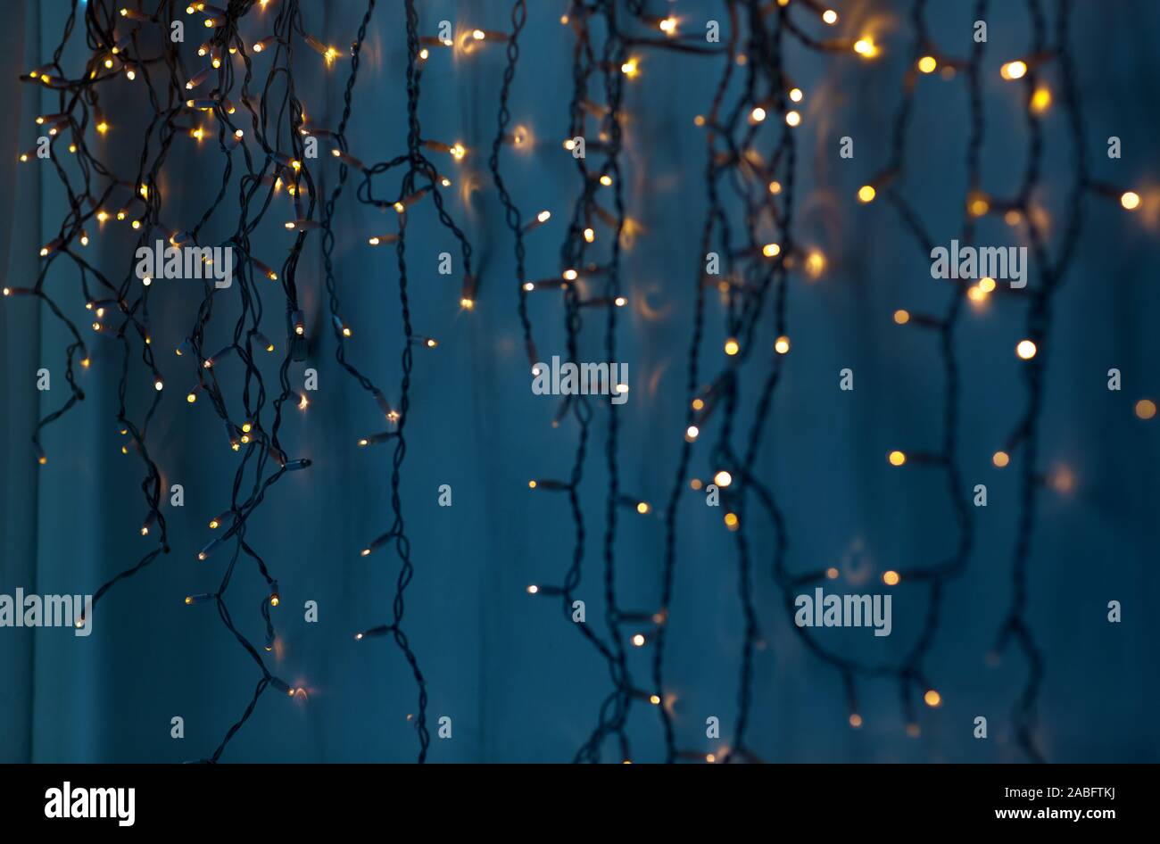 christmas garland lights over dark blue background Stock Photo Alamy
