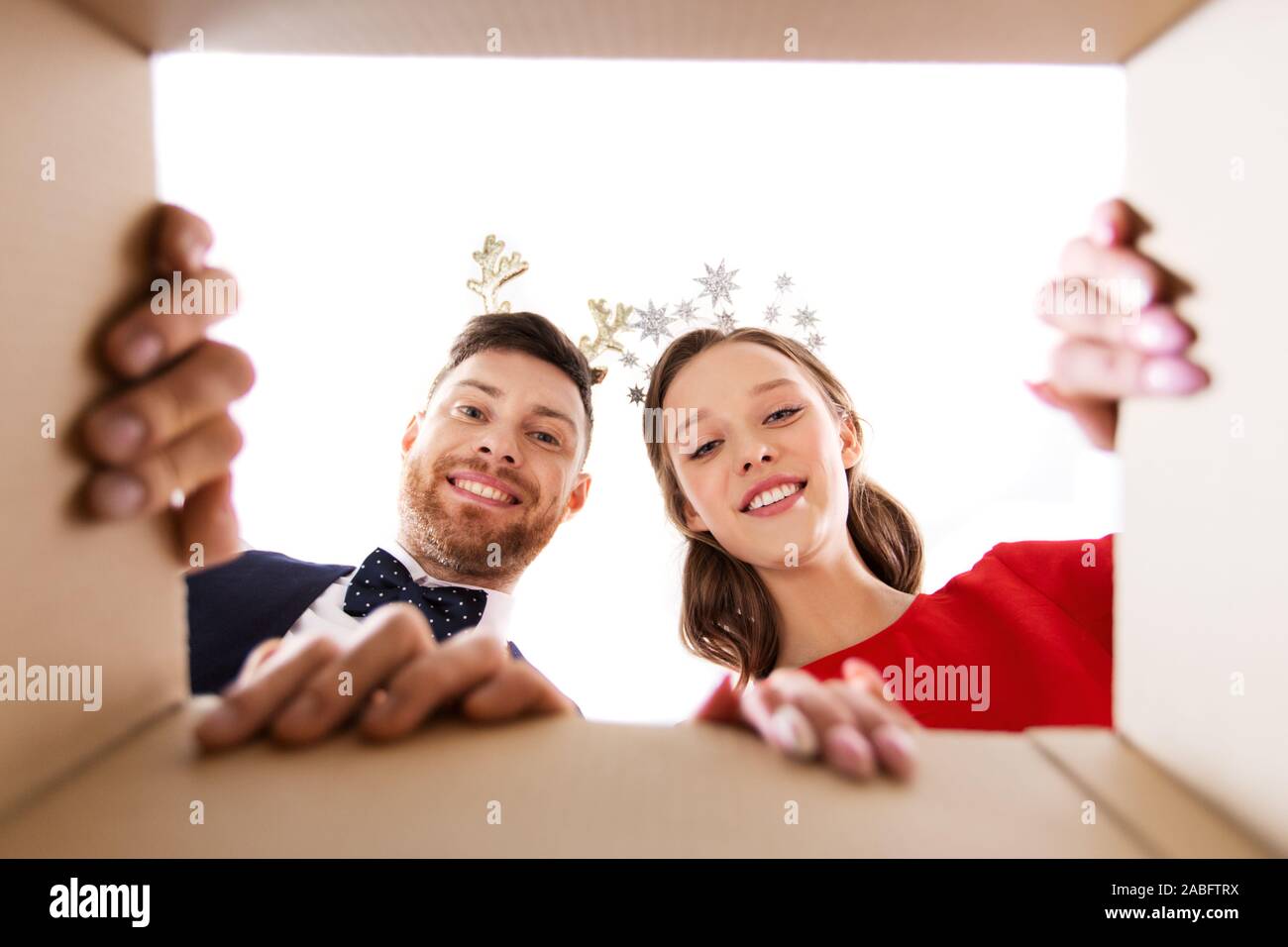 happy couple opening christmas gift box Stock Photo