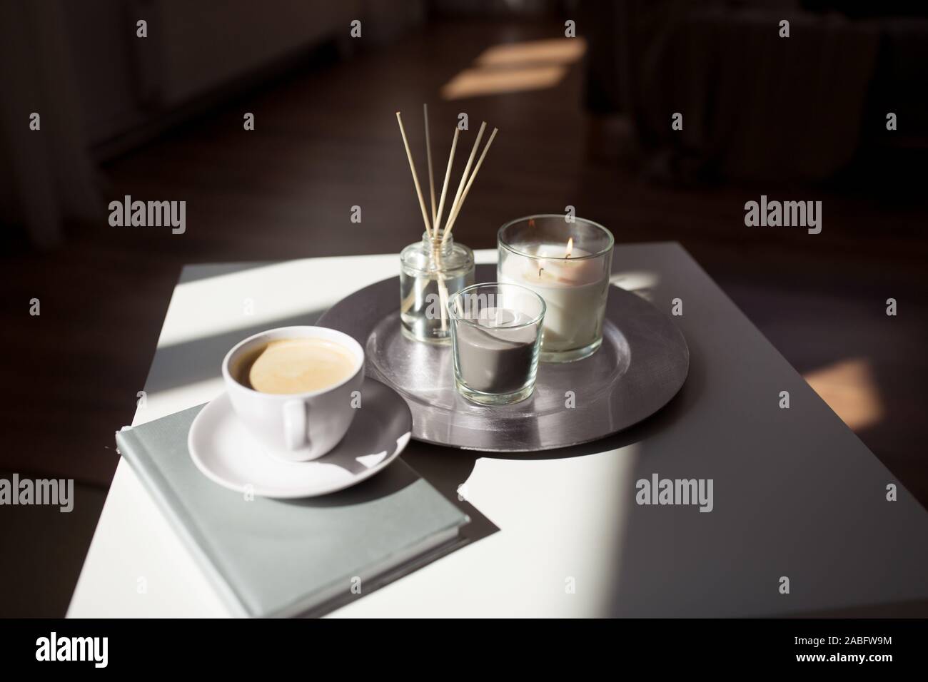 coffee, candles and aroma reed diffuser on table Stock Photo