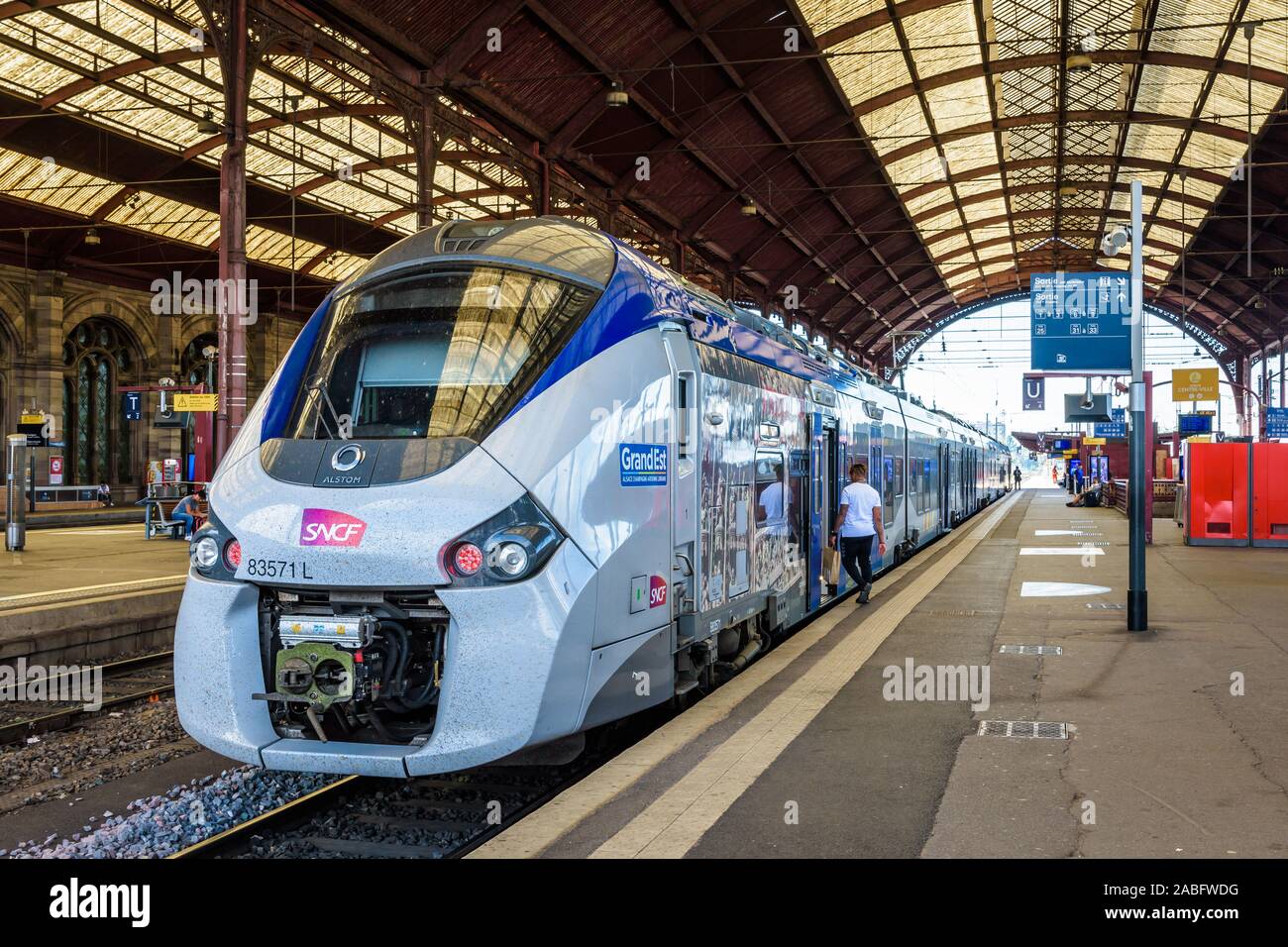 A Regiolis TER regional train from french company SNCF is stationing at the platform in Strasbourg train station, waiting for passengers to get on. Stock Photo