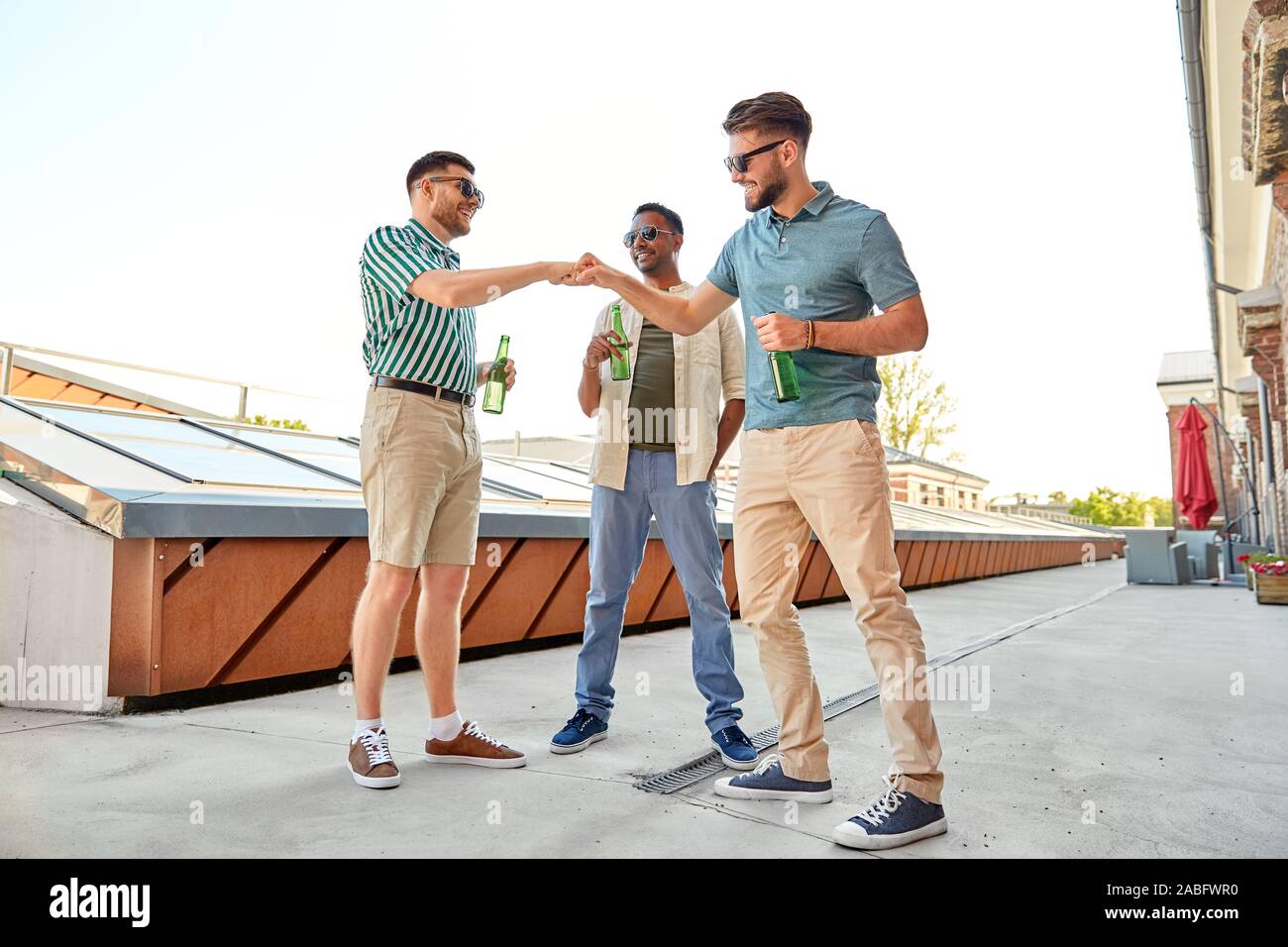 Beer Meating happy male friends with beer meeting on rooftop Stock Photo - Alamy