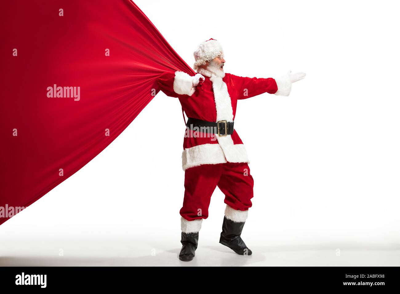 Santa Claus pulling huge bag full of christmas presents isolated on ...