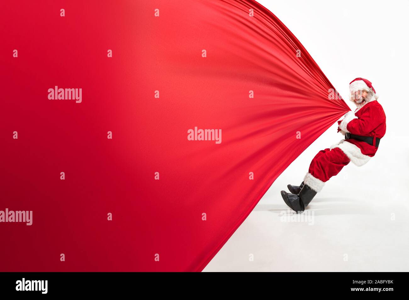 Santa Claus pulling huge bag full of christmas presents isolated on ...