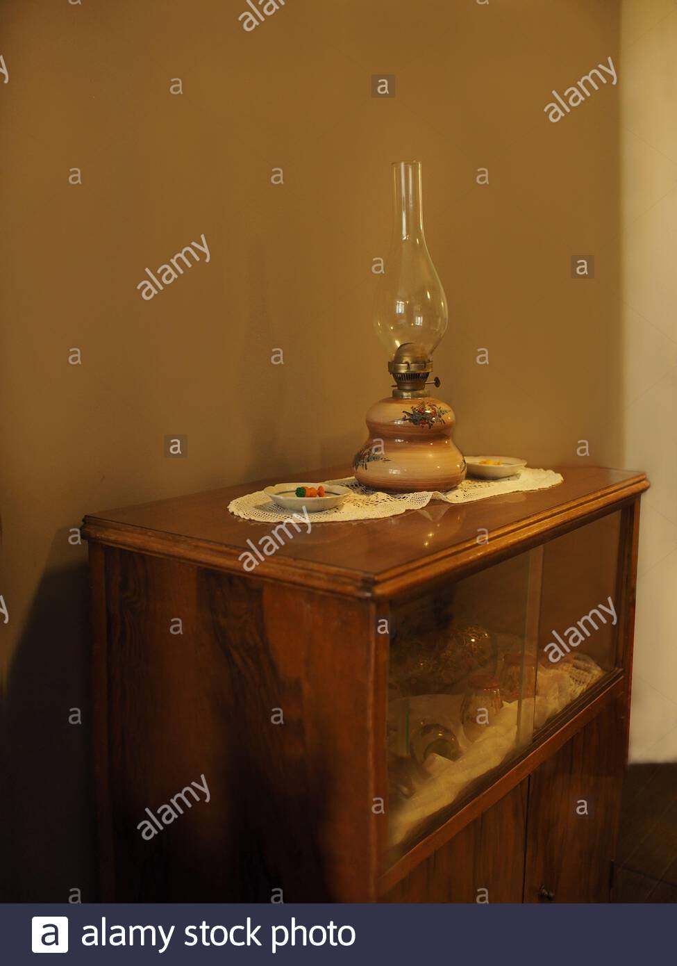 Traditional Interior Oil Lamp On A Wooden Chest Of Drawers With
