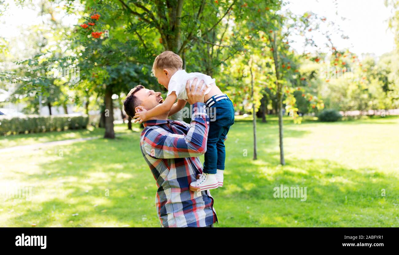 happy father with son playing in summer park Stock Photo - Alamy