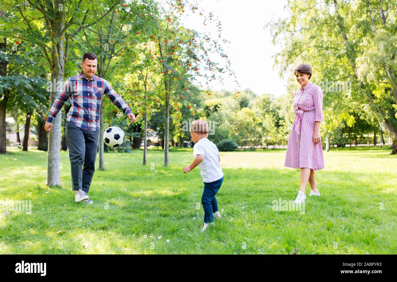 happy family playing soccer at summer park Stock Photo - Alamy