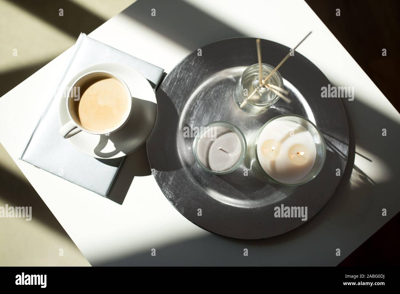 coffee, candles and aroma reed diffuser on table Stock Photo